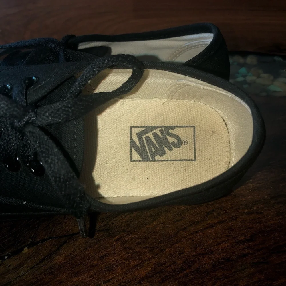 Vans all black kids lace up skateboard shoes.